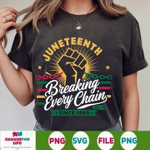 May include: Dark gray t-shirt with a graphic design celebrating Juneteenth. The design features a raised fist, the words "Juneteenth" and "Breaking Every Chain," and the date "Since 1865." The design incorporates red, yellow, green, and black colors.