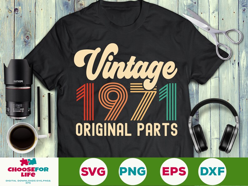 May include: A black t-shirt with a vintage-style design featuring the year 1971 in colorful stripes and the text "Vintage 1971 Original Parts".