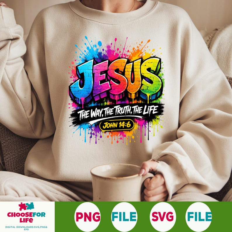 May include: A beige crewneck sweatshirt featuring a colorful graffiti-style graphic that reads JESUS THE WAY, THE TRUTH, THE LIFE and JOHN 14:6. The design includes vibrant paint splatters in blue, purple, red, orange, yellow, and green.
