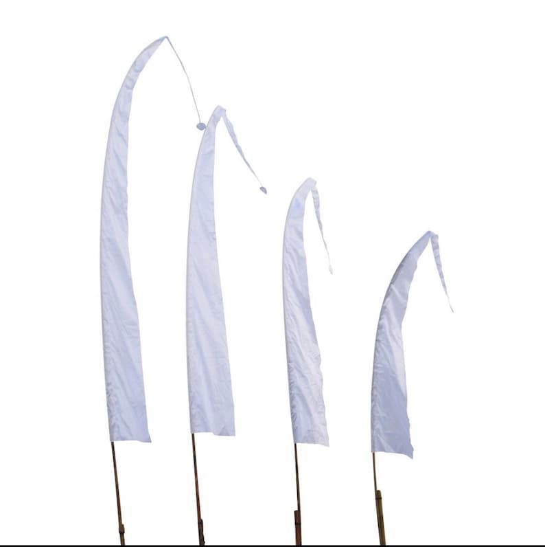 May include: Four white fabric flags on wooden poles, arranged in descending size order. The flags are all white and have a slightly curved shape.