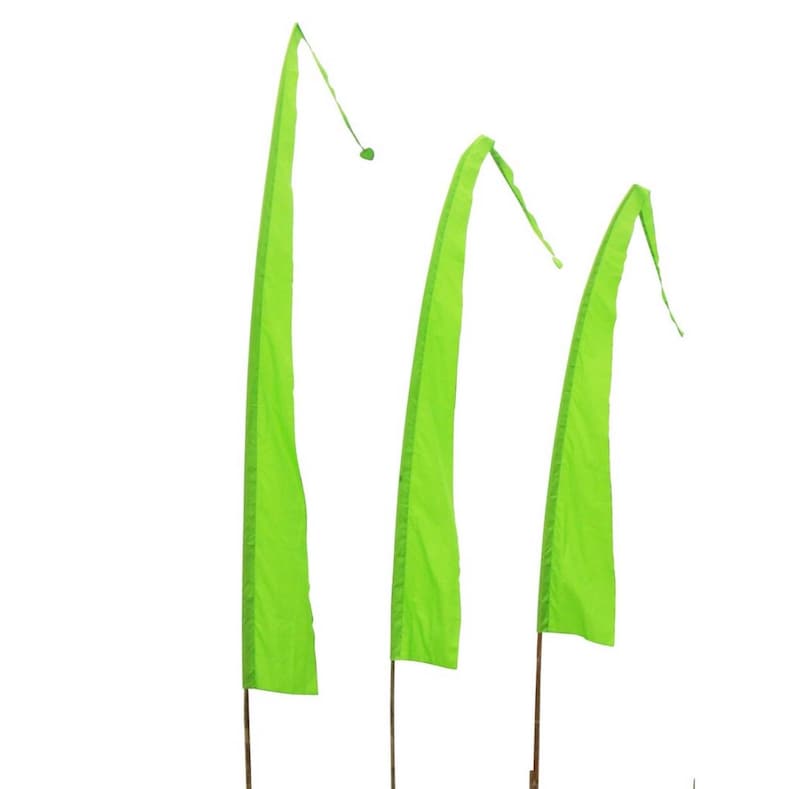 May include: Three green fabric pennants with pointed ends, hanging from wooden poles against a white background.