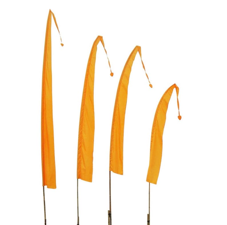 May include: Four orange fabric flags on poles, each with a rounded top and a small tassel. The flags are arranged in a row, with the largest flag on the left and the smallest flag on the right.