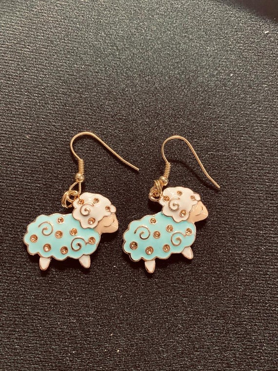 Blue & White Sheep Dangle Earrings With A Gold Tone Finish Blue & White Sheep Dangle Earrings With A Gold Tone Finish