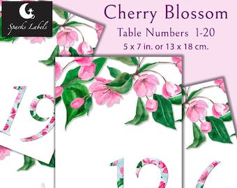 May include: Printable table numbers featuring a watercolor design of pink cherry blossoms and green leaves. The numbers are 5 x 7 inches or 13 x 18 centimeters. The text "table" is included on the card.