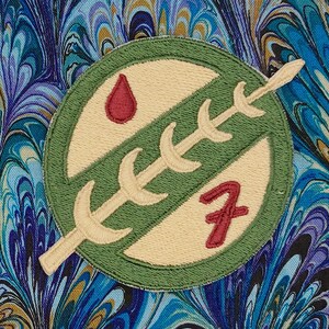 May include: A green and beige embroidered patch with a stylized plant and a red number 7. A red blood drop is in the upper left corner of the patch.