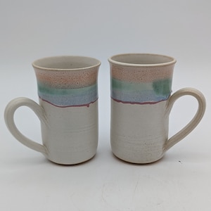 Pair of Studio Pottery Mugs in Cream with Orange, Green and Blue Colors Signed Jan
