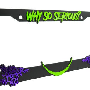 May include: Black license plate frame with a green "Why So Serious?" text and purple "Ha Ha Ha" text.