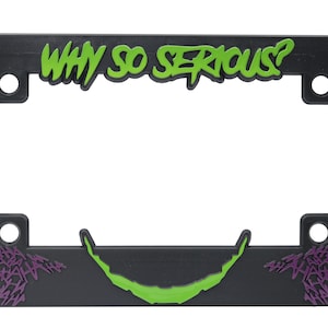 May include: Black plastic license plate frame with green and purple text that reads "WHY SO SERIOUS?" and a green and purple Joker-style smile.