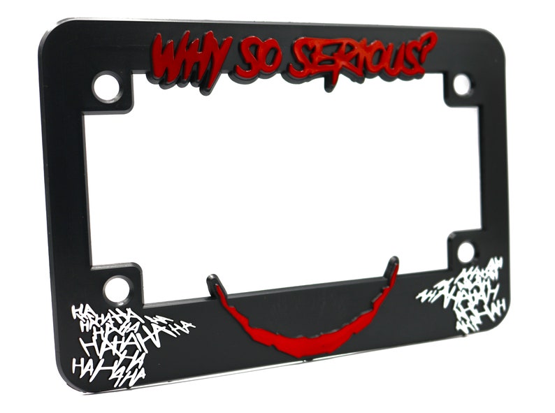 May include: Black plastic license plate frame with a red and white graphic of the Joker's face and the text "WHY SO SERIOUS?"