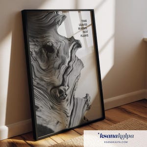 May include: Black framed art print featuring a close-up of a weathered wood grain pattern in shades of gray and white. The print includes the text "TIME LEAVES MARKS, NOT FLAWS". The artwork is leaning against a wall.