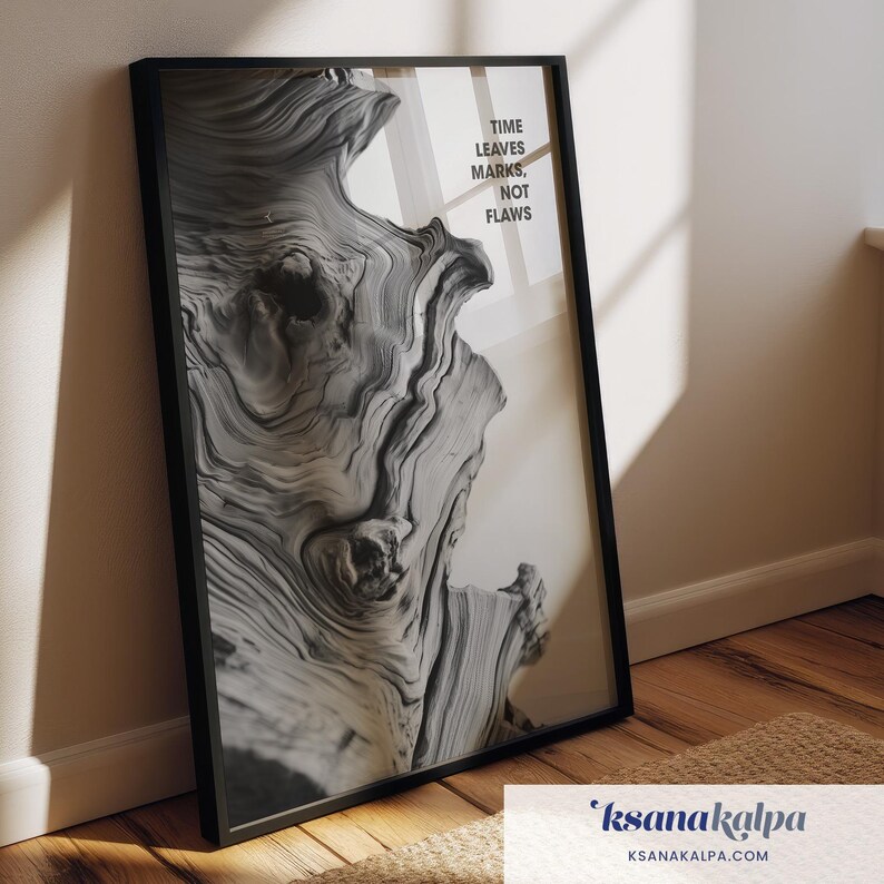May include: Black framed art print featuring a close-up of a weathered wood grain pattern in shades of gray and white. The print includes the text "TIME LEAVES MARKS, NOT FLAWS". The artwork is leaning against a wall.