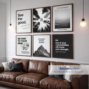 May include: A gallery wall arrangement featuring six framed prints with inspirational quotes and nature-themed imagery. The prints include phrases like "See the good" and "Stillness builds clarity." The frames are dark brown, and the wall is above a brown leather sofa.