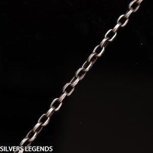 May include: A silver chain necklace with a simple, classic design. The chain is made of small, oval-shaped links.