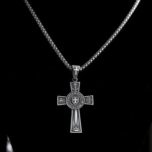 May include: A silver chain necklace with a silver cross pendant. The cross features a circular design with the words "TEMPLI SIGNUM" and "IHS" around the edge. The center of the circle has a shield with a cross and a sword.