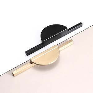 May include: Two cabinet pulls, one black and one gold, with a half-circle design.