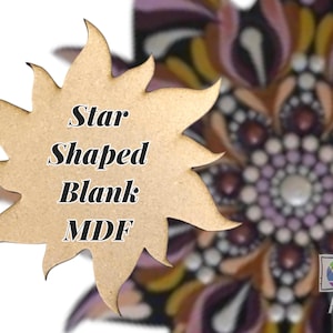 May include: A star-shaped MDF blank with the text "Star Shaped Blank MDF" in black. The background features a colorful, detailed mandala design with shades of purple, brown, and yellow.