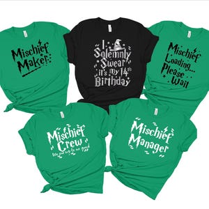 May include: Five green t-shirts with black and white text. The shirts say "Mischief Maker", "Mischief Crew", "Mischief Manager", "Solemnly Swear it's My 14th Birthday", and "Mischief Loading... Please Wait".