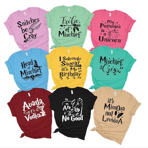 May include: Nine different Harry Potter themed t-shirts with various sayings and graphics. The shirts are in different colors, including pink, green, yellow, blue, red, black, and beige.