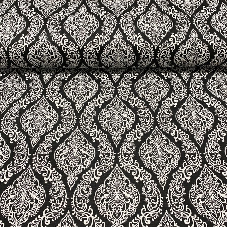 May include: Black and white fabric with a damask pattern. The pattern features intricate details and a repeating design.