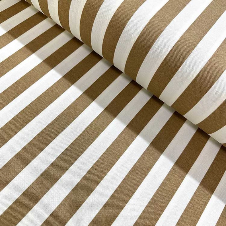 May include: Brown and white striped fabric. The fabric is folded in half, showing the stripes running diagonally.
