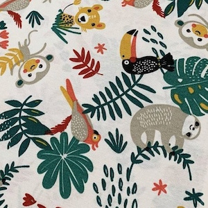 May include: White fabric with a repeating pattern of jungle animals and plants. The animals include a toucan, a sloth, a monkey, and a leopard. The plants are green and red.