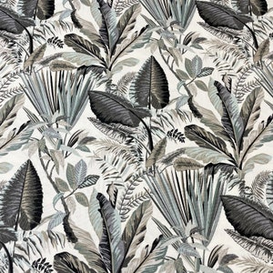 May include: A fabric featuring a tropical leaf design. The pattern showcases large, stylized leaves in shades of grey, black, and muted green against a white backdrop. The leaves vary in size and shape, creating a dense, jungle-like effect.