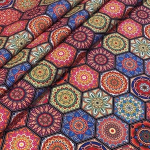 May include: A colorful fabric with a repeating pattern of hexagonal tiles. Each tile features a detailed mandala design in shades of red, orange, yellow, blue, green, and purple. The fabric has a dark background.