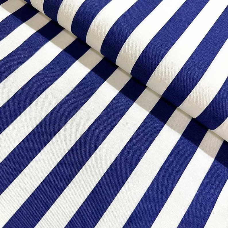 May include: White and navy blue striped fabric. The fabric is folded in half, showing the stripes running diagonally.