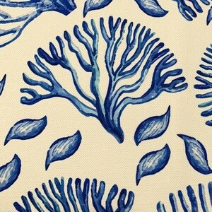 May include: A white background with a repeating pattern of blue coral and leaves. The coral is stylized and has a blue and white color gradient. The leaves are a solid blue.