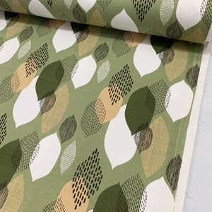 May include: Green fabric with a repeating pattern of white, tan, and green leaves. The leaves are stylized and have a geometric design.