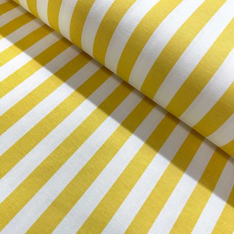 May include: Yellow and white striped fabric. The fabric has a smooth texture and is perfect for sewing projects.
