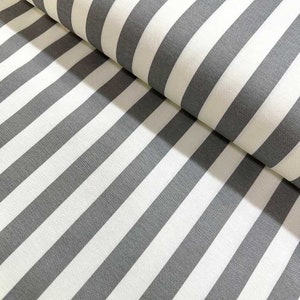 May include: White and gray striped fabric with a subtle texture. The fabric is folded in half, showing the pattern on both sides.