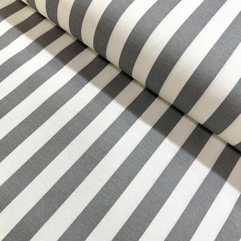 May include: White and gray striped fabric with a subtle texture. The fabric is folded in half, showing the pattern on both sides.