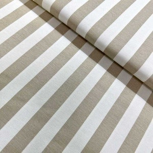 May include: Beige and white striped fabric with a subtle texture. The fabric is folded in half, showing the pattern on both sides.
