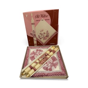 May include: A vintage gift set featuring candles and napkins. The box reads "Old Willow Candles and Napkins." The set includes two candles with a red and cream design, and napkins with a matching pattern. The box is pink and brown.
