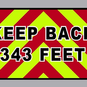 May include: A yellow and red chevron patterned sign with black text that reads "KEEP BACK 343 FEET".