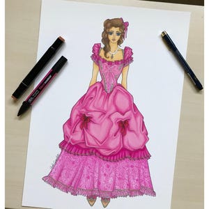 May include: A fashion illustration on white paper depicting a figure wearing a voluminous pink ball gown with ruffled sleeves, a central bow, and a textured, patterned skirt. Two markers are placed on the paper, one black and one pink.