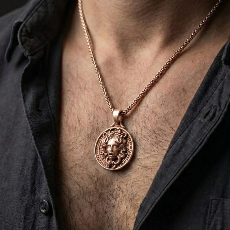 Rose gold plated Medusa necklace worn on model with timeless classical warrior style