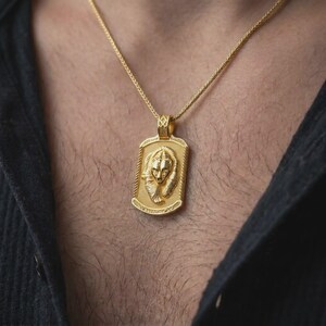 Gold plated bear and cub necklace worn on the chest, highlighting the nestled bear portraits, detailed fur texture, and symbolic family strength and protection jewelry design.
