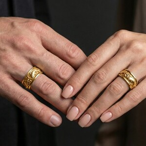 Gold plated dragon and koi fish band worn on finger, sculpted Japanese-inspired relief detail, premium lifestyle jewelry photo.