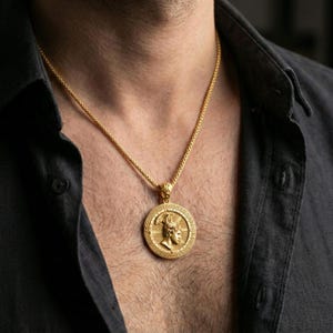 Gold plated Perseus coin pendant necklace worn on the neck, lifestyle photo featuring warm tone finish and strong statement medallion presence.