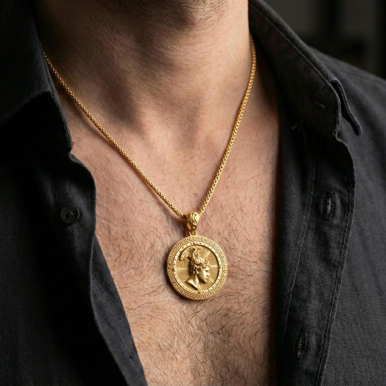 Gold plated Perseus coin pendant necklace worn on the neck, lifestyle photo featuring warm tone finish and strong statement medallion presence.
