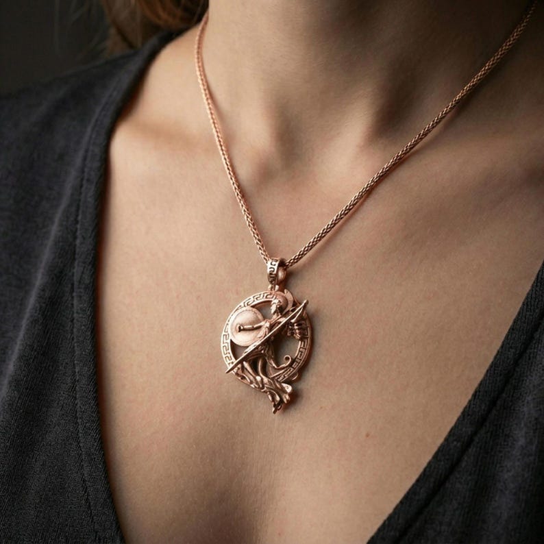 Rose gold plated Athena warrior pendant necklace worn on the neck, lifestyle wear shot with elegant rosy shine and crisp Greek key border detailing visible.