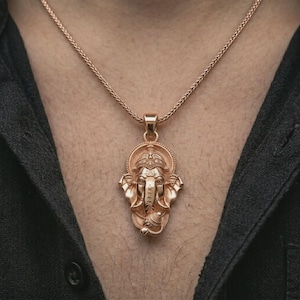 Rose gold plated Ganesha pendant necklace worn on the chest, close-up lifestyle shot featuring the sacred elephant god design with warm rose gold tones.