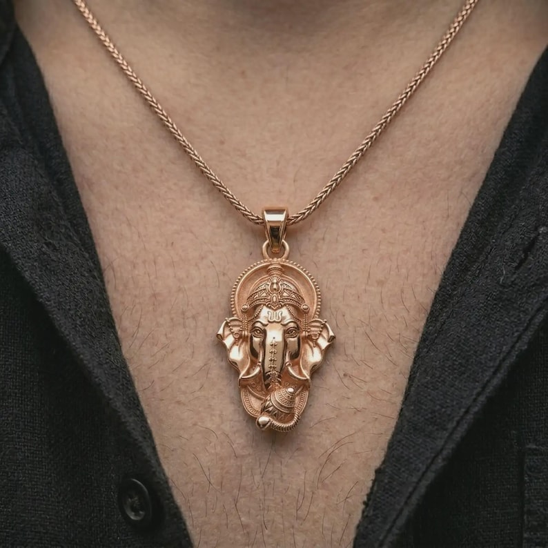 Rose gold plated Ganesha pendant necklace worn on the chest, close-up lifestyle shot featuring the sacred elephant god design with warm rose gold tones.