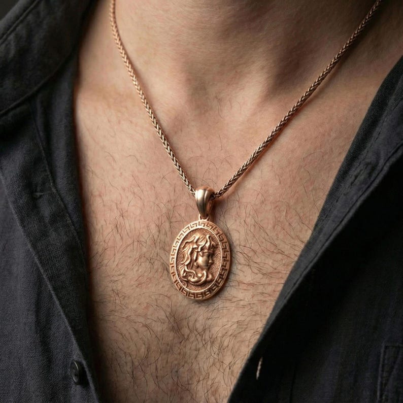 Rose gold plated Medusa coin necklace worn on neck, Greek key medallion with Medusa profile relief and premium vintage look