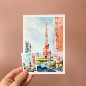 May include: A watercolour painting of the Tokyo Tower in Japan. The tower is red and white and is surrounded by buildings and trees. There is a smaller version of the painting in the bottom left corner of the image.