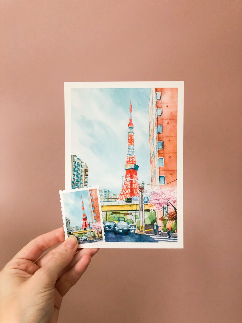 May include: A watercolour painting of the Tokyo Tower in Japan. The tower is red and white and is surrounded by buildings and trees. There is a smaller version of the painting in the bottom left corner of the image.
