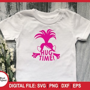 May include: White t-shirt featuring a pink graphic of a cartoon character with the text "HUG TIME!". The shirt has short sleeves and a crew neck. The design includes the words "DIGITAL FILE: SVG | PNG | DXF | EPS".