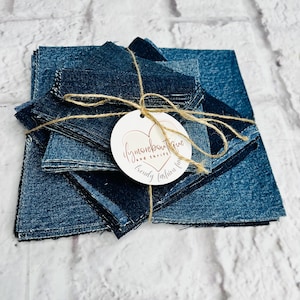 May include: A bundle of denim fabric squares, secured with twine, and a round tag with the text "ifymoreboutique" and "trendy fashion fun". The denim pieces are various shades of blue, creating a textured appearance.